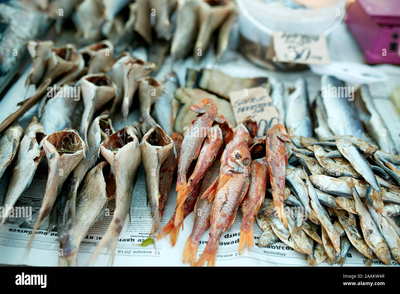 Dried fish on rope at stall on summer market for sale. Salted local
