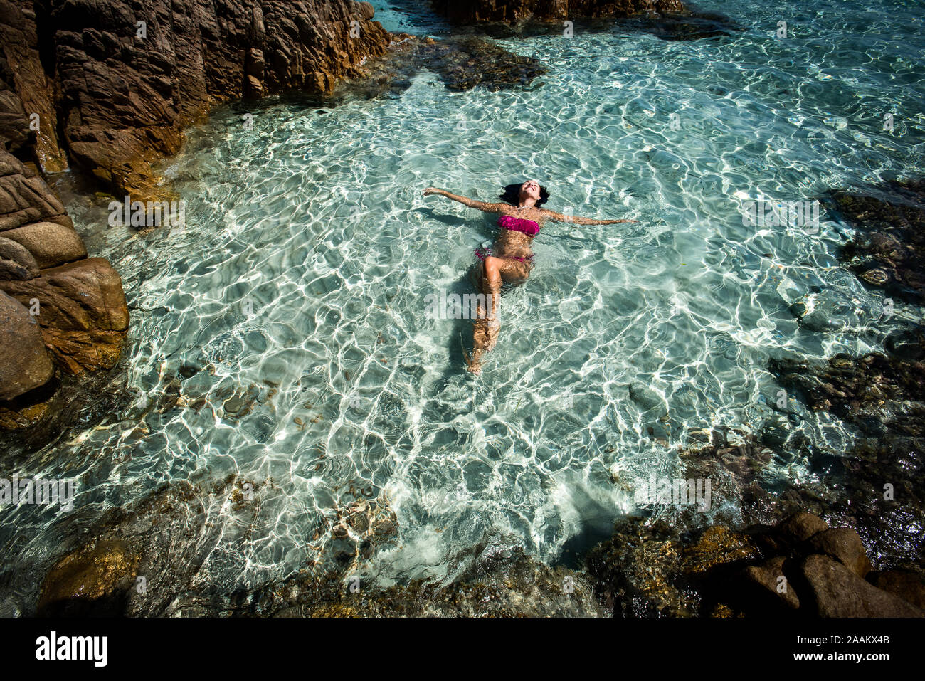 Woman in bikini enjoying clear sea water in lagoon, La Maddalena island,  Sardegna, Italy Stock Photo - Alamy