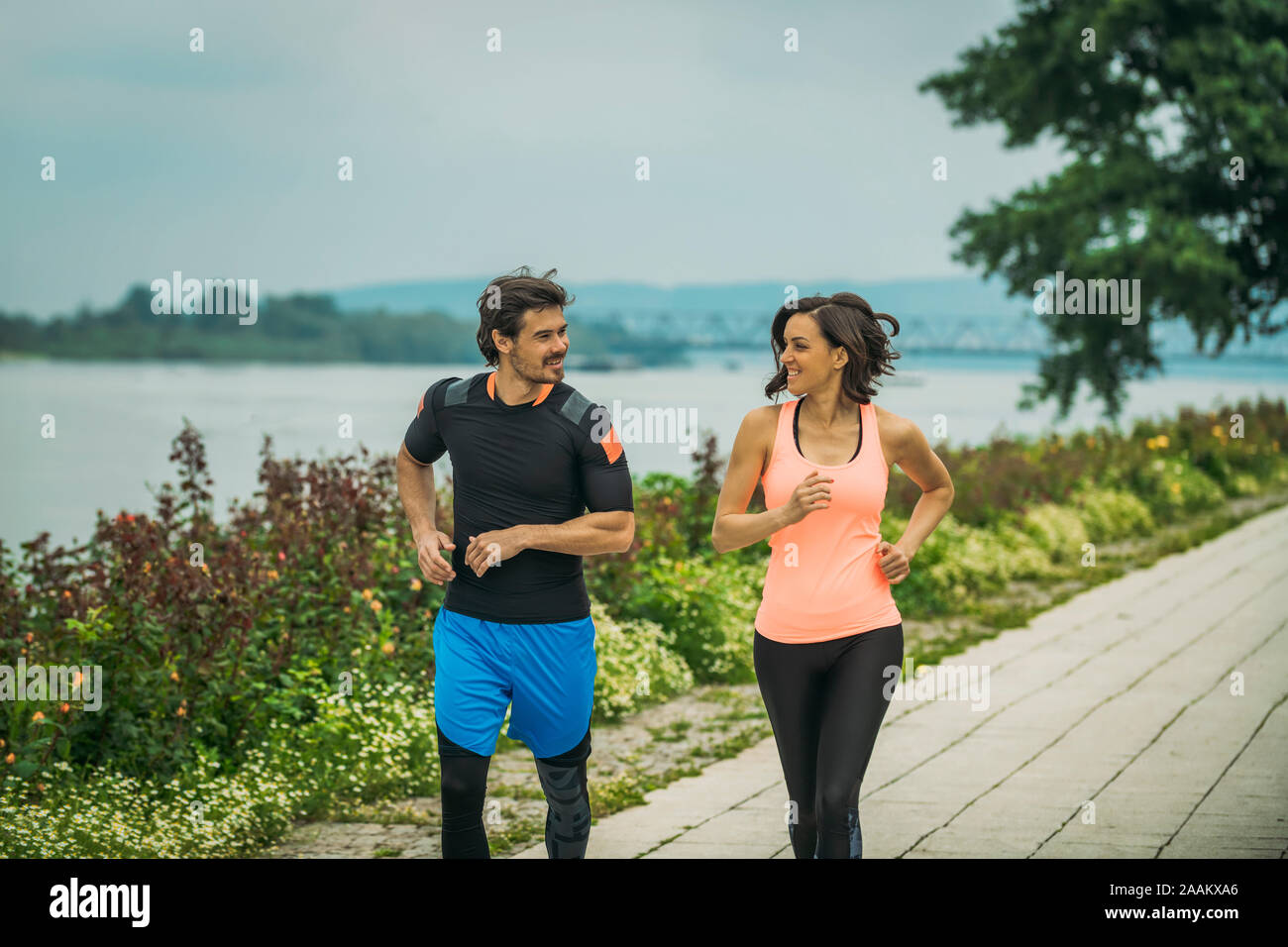 Exercising by the river with personal trainer. Stock Photo