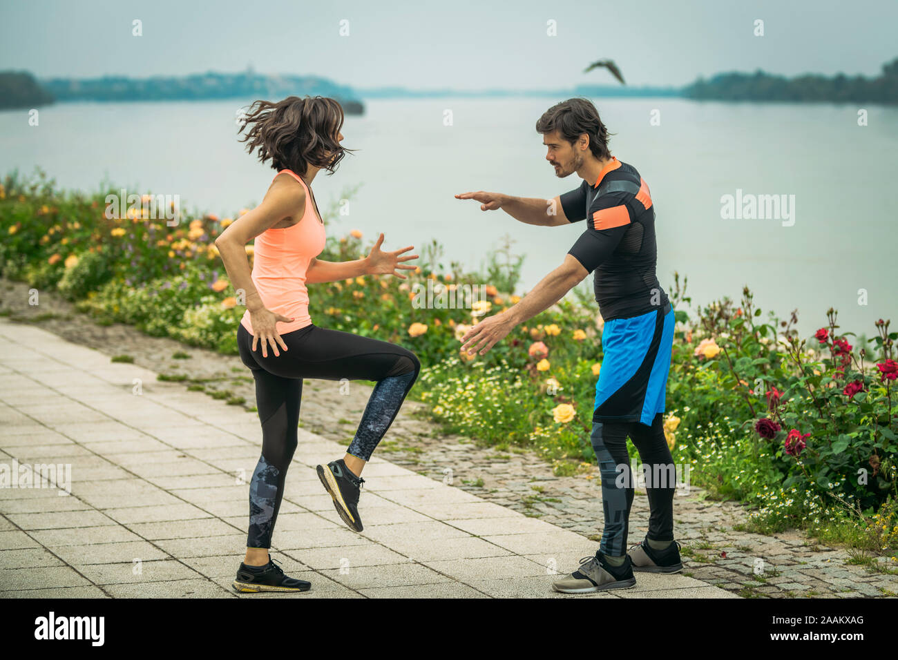 Exercising by the river with personal trainer. Stock Photo