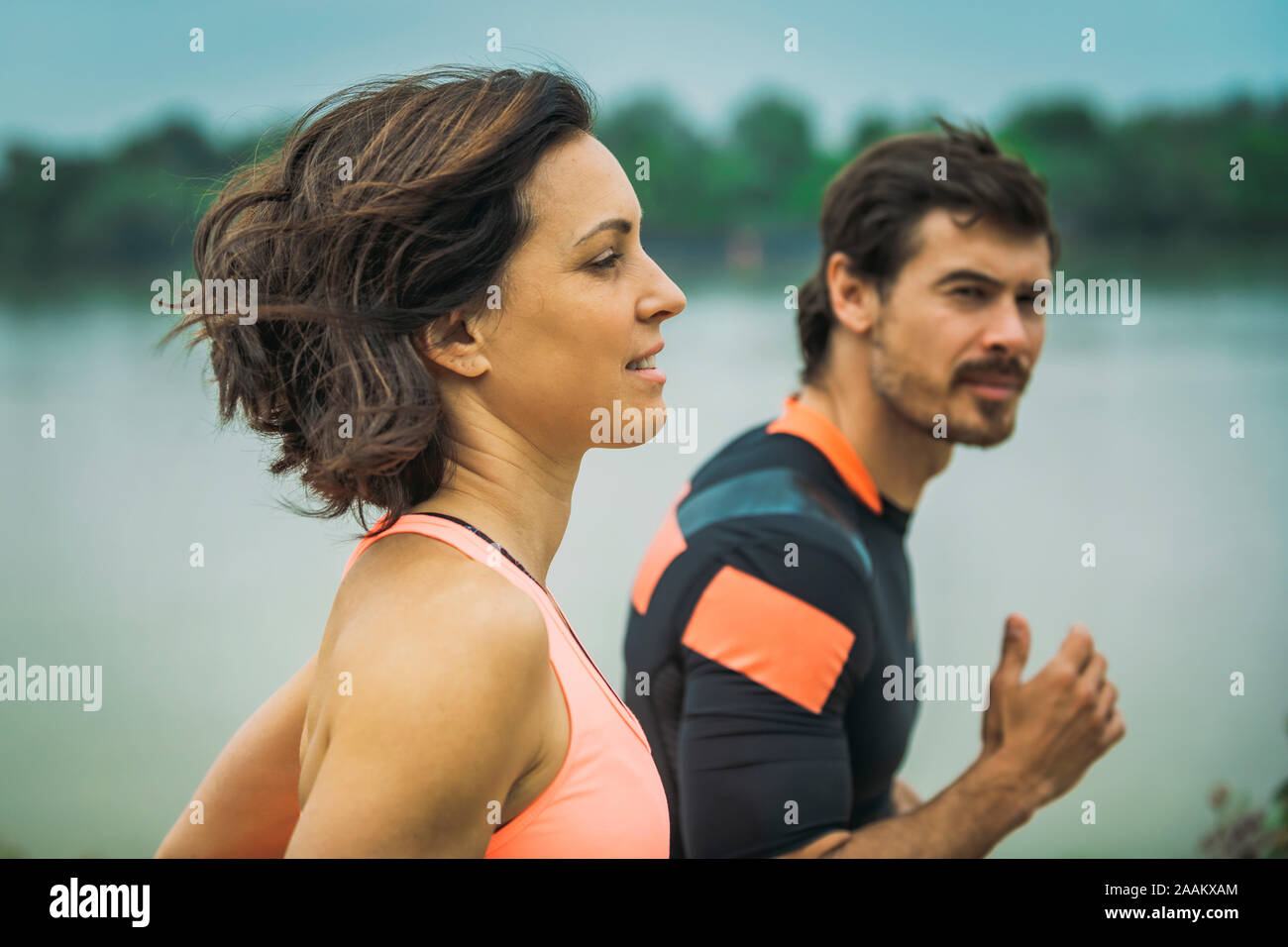 Exercising by the river with personal trainer. Stock Photo