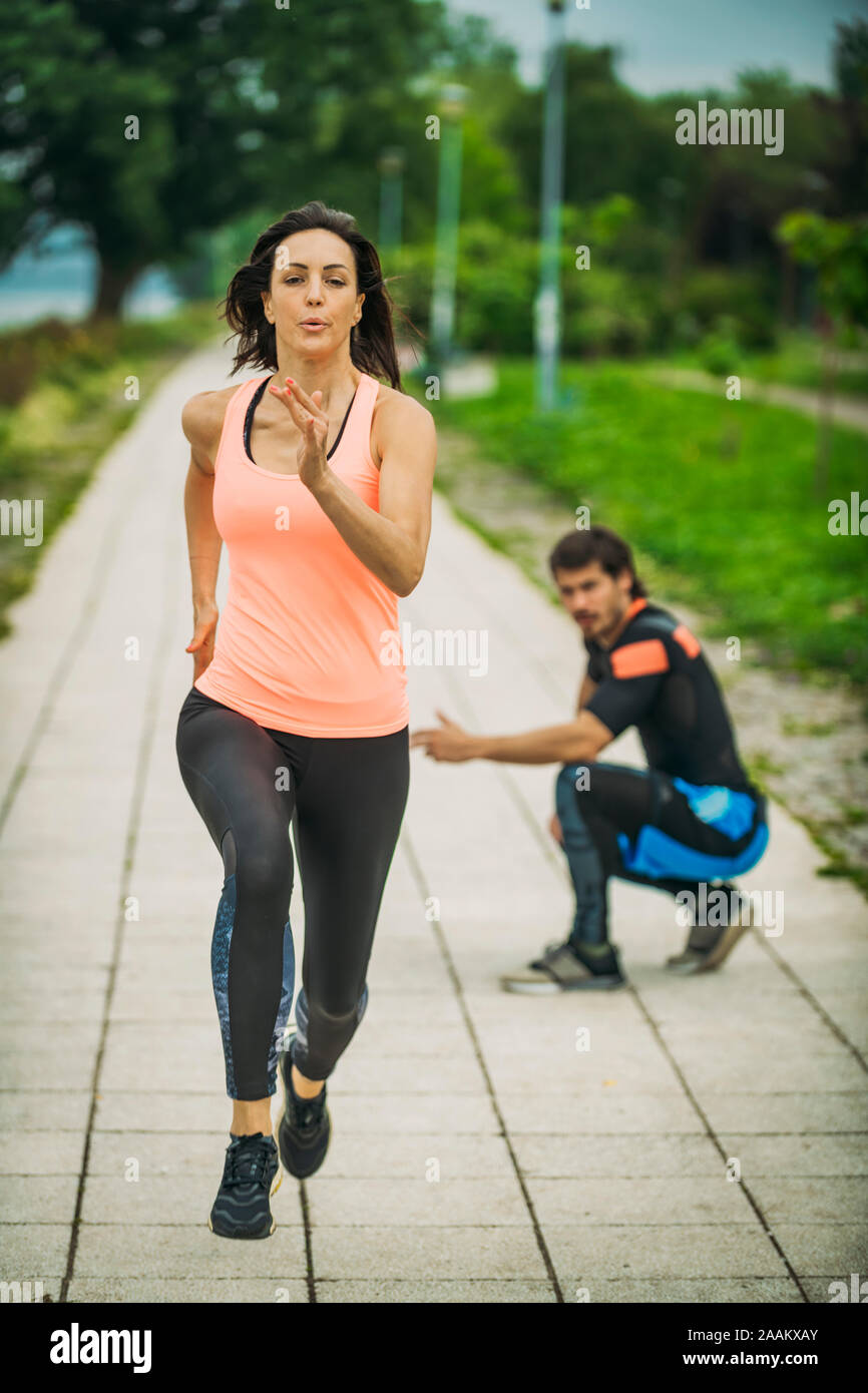 Exercising by the river with personal trainer. Stock Photo
