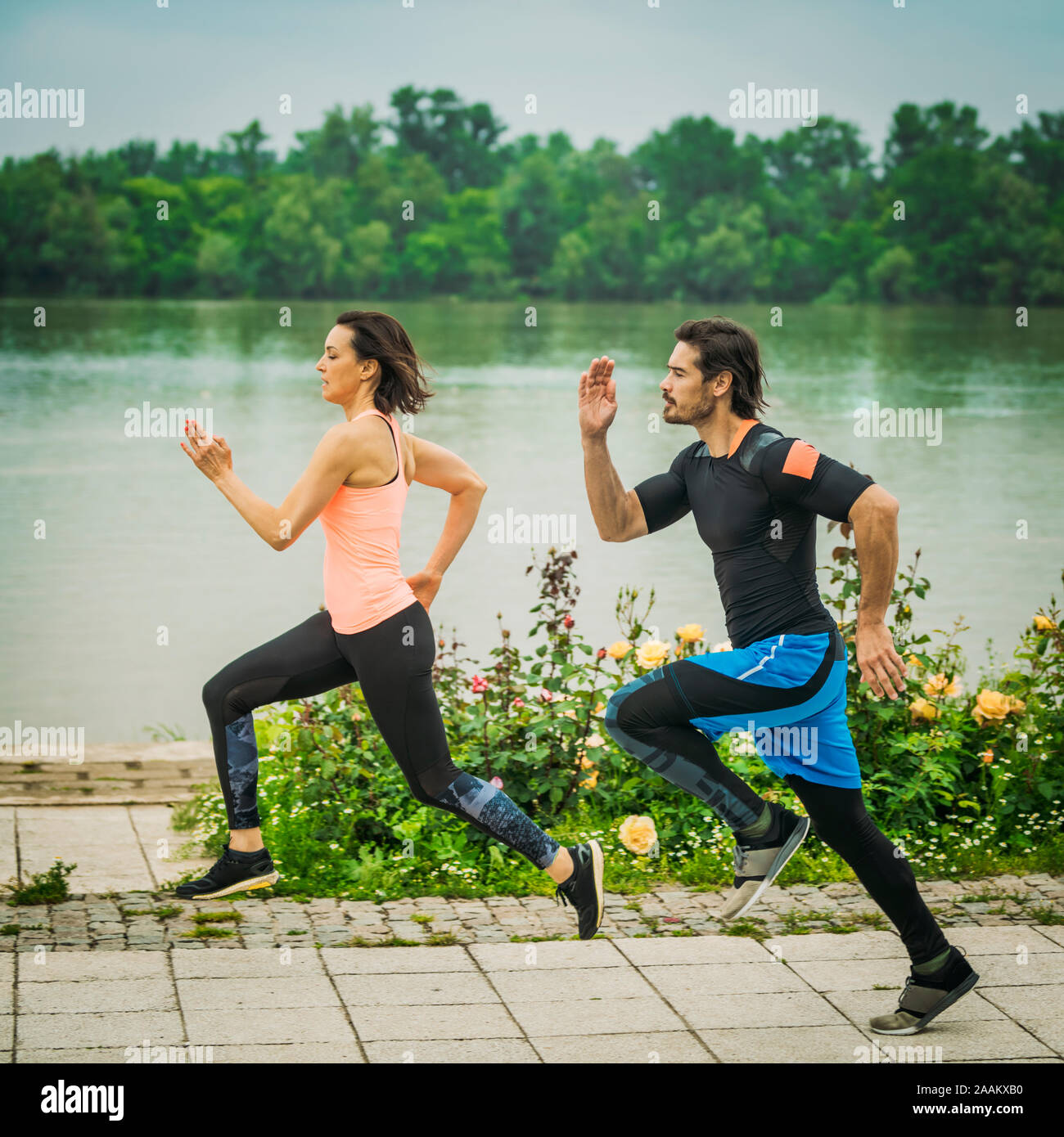 Exercising by the river with personal trainer. Stock Photo