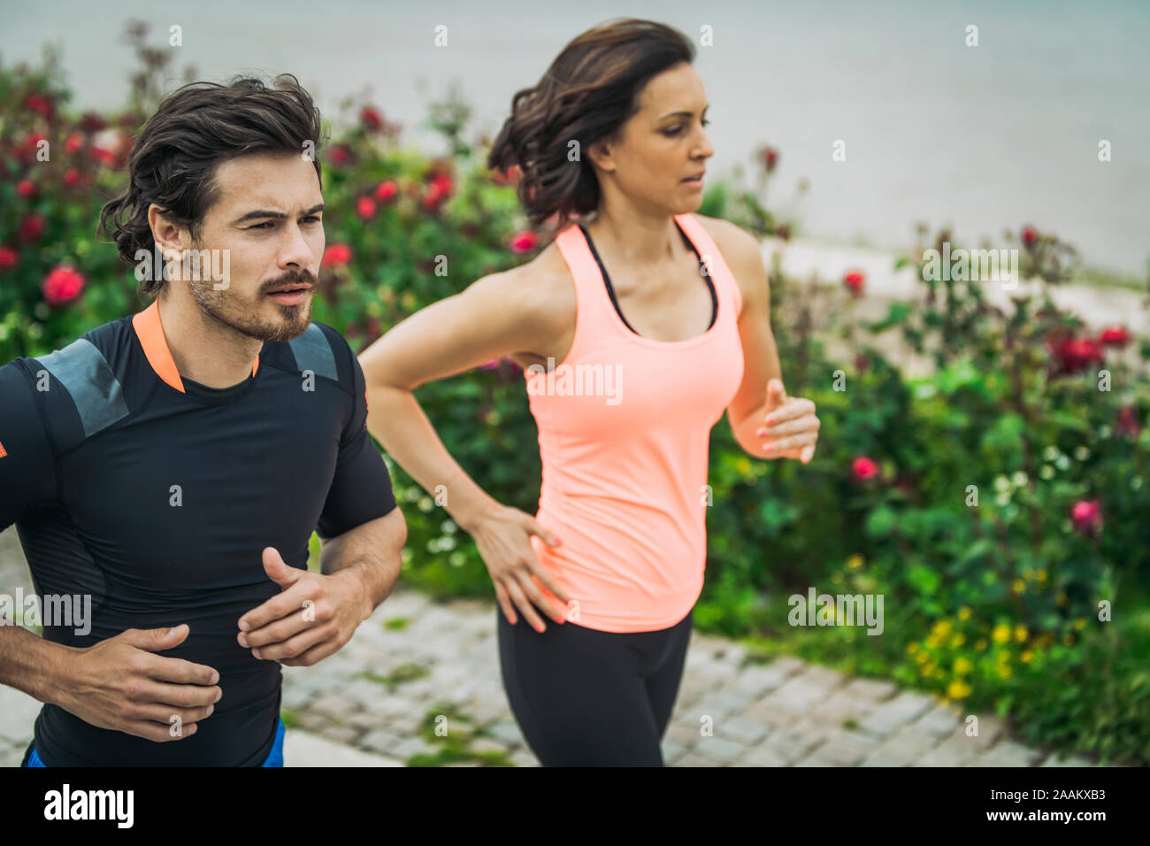 Exercising by the river with personal trainer. Stock Photo