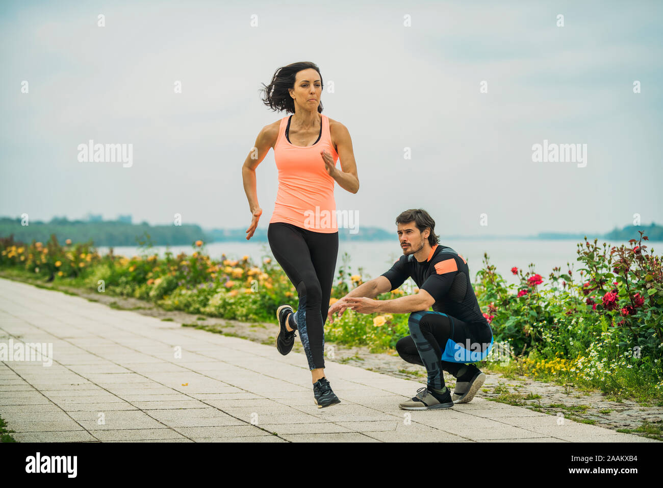 Exercising by the river with personal trainer. Stock Photo