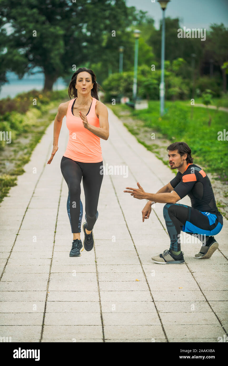 Exercising by the river with personal trainer. Stock Photo