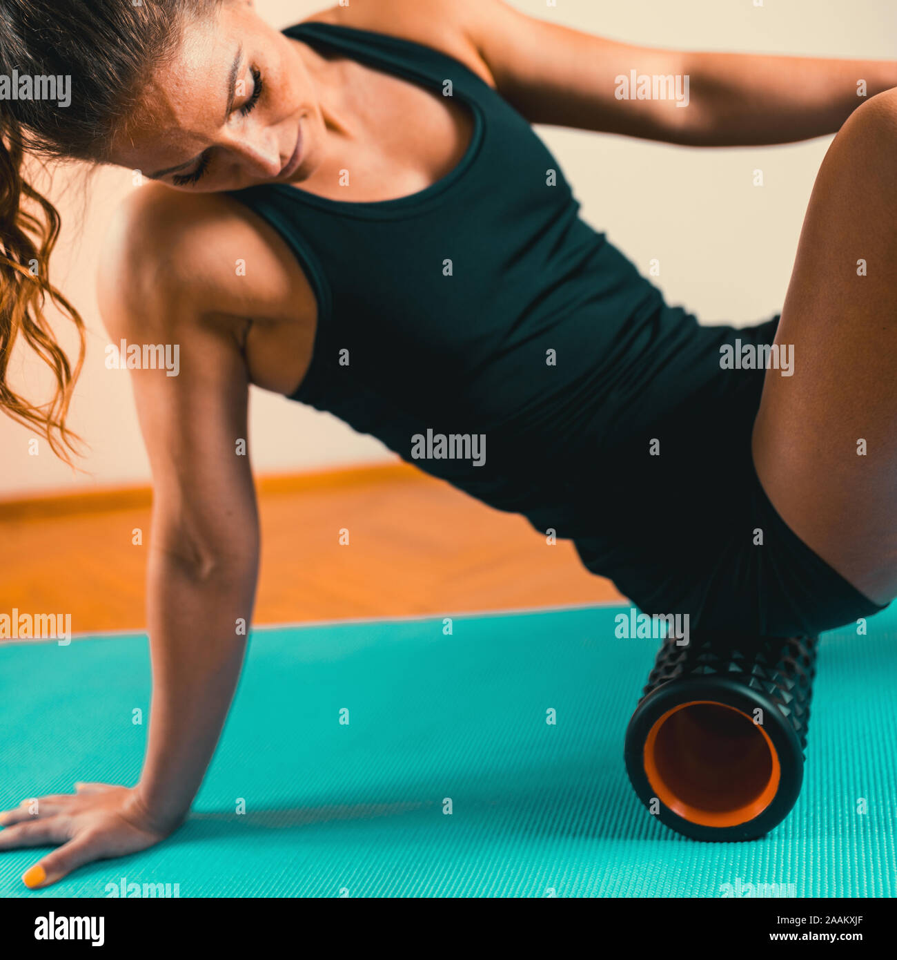 Foam roller. Woman using foam roller for muscle and fascia massage