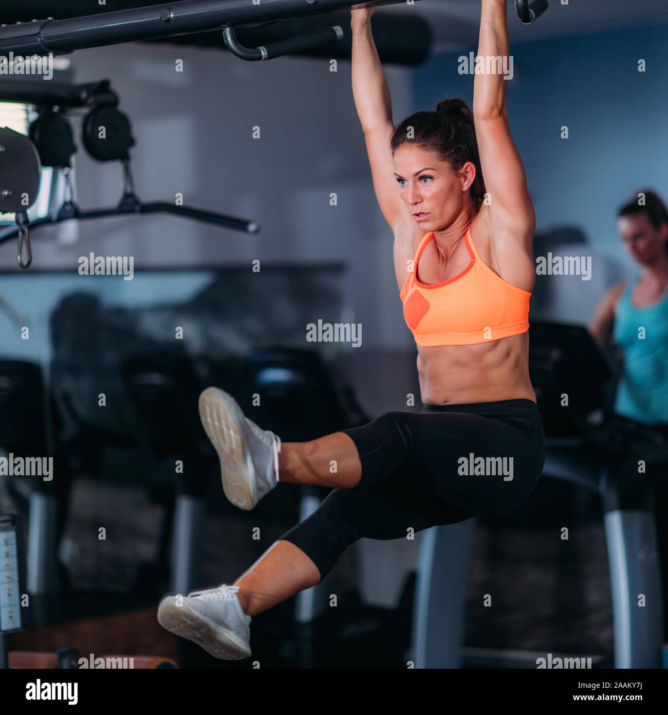 Female athlete doing pull-ups in the gym Stock Photo - Alamy