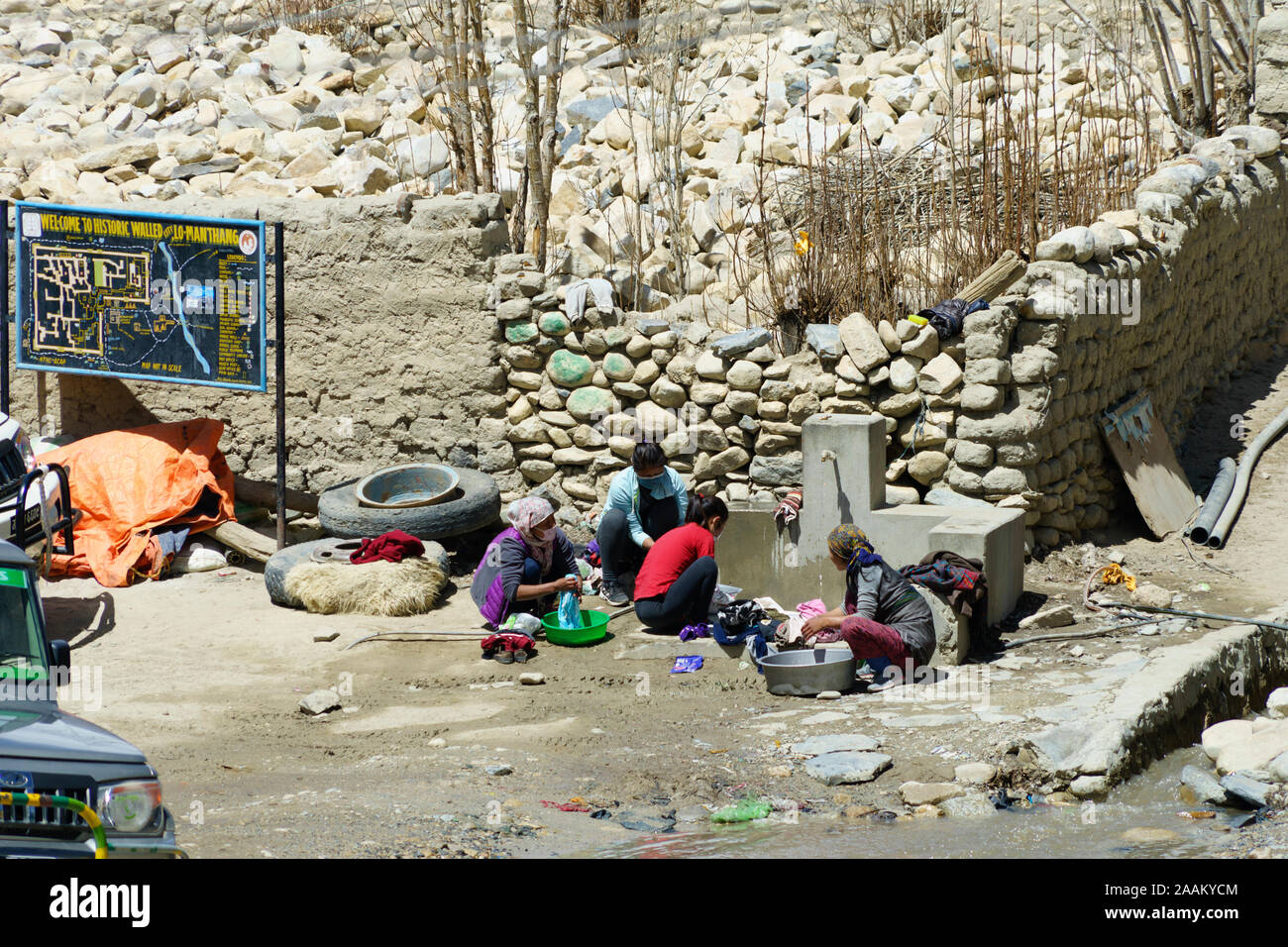 Loba women washing clothes at a public water source in Lo Manthang, Upper Mustang region, Nepal. Stock Photo