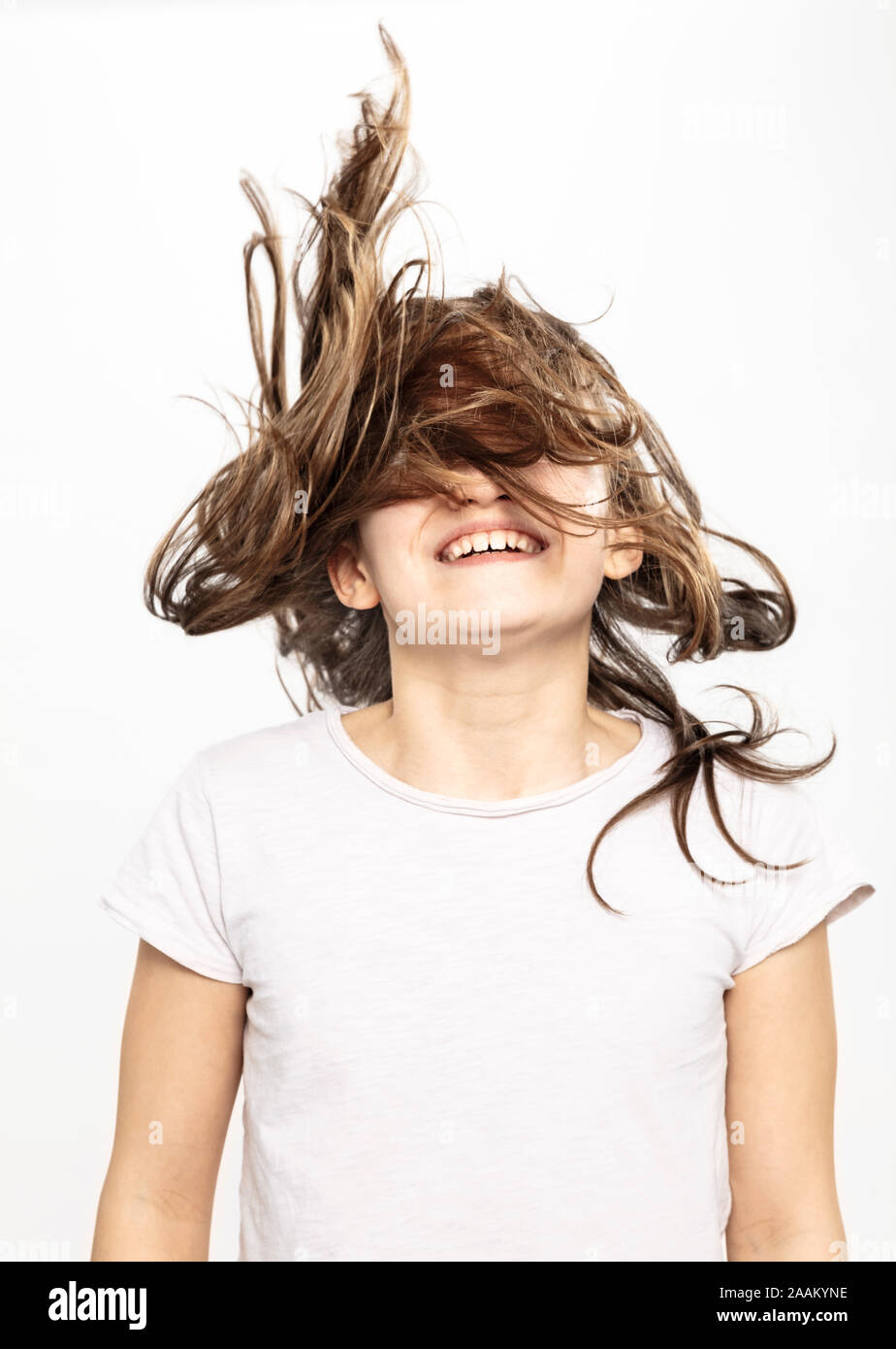 Happy girl with flying hair, white background Stock Photo