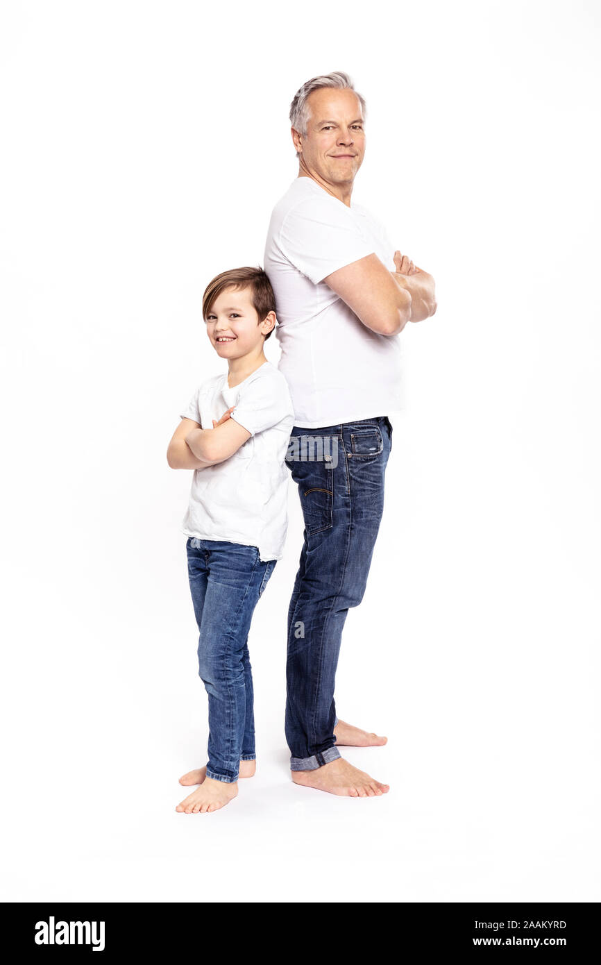 Father and son with arms crossed, white background Stock Photo