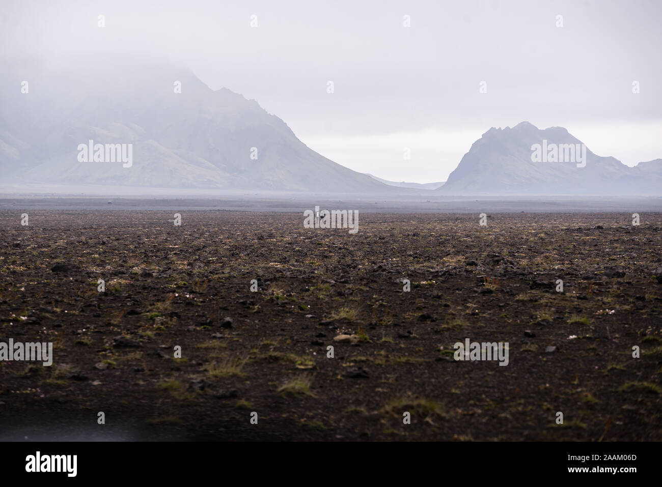 Two people in middle of vast flat landscape, Landmannalaugar, Iceland Stock Photo