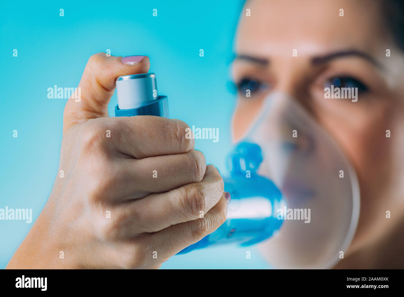 Woman using asthma inhaler with extension tube Stock Photo Alamy