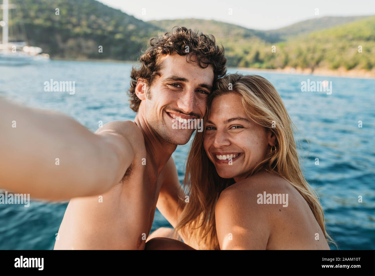 Couple taking selfie by seaside, Italy Stock Photo
