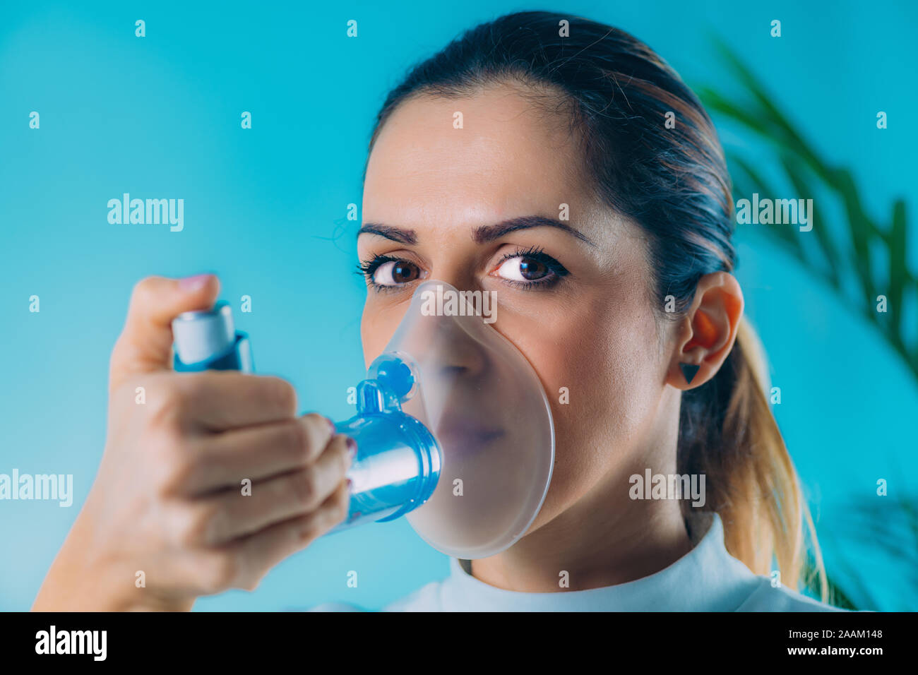 Woman using asthma inhaler with extension tube Stock Photo Alamy