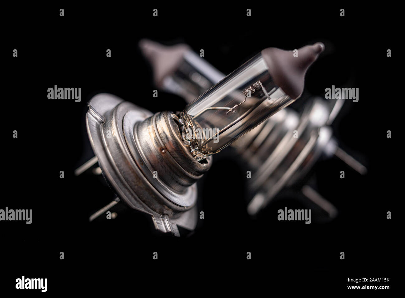 Blown car bulbs on a dark table. Spare parts for passenger cars. Black background Stock Photo