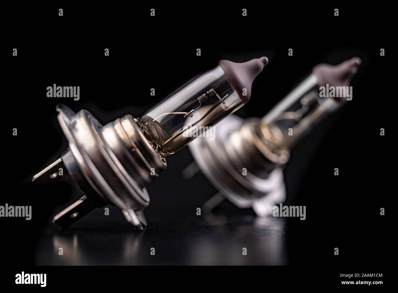 Blown car bulbs on a dark table. Spare parts for passenger cars. Black background Stock Photo