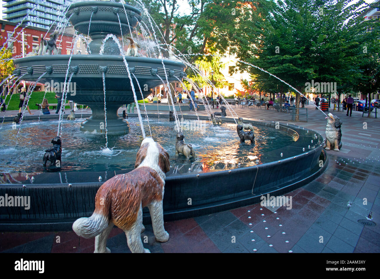 Unique fountain surrounded by stone canine sculptures in Berczy Park in downtown Toronto, Canada