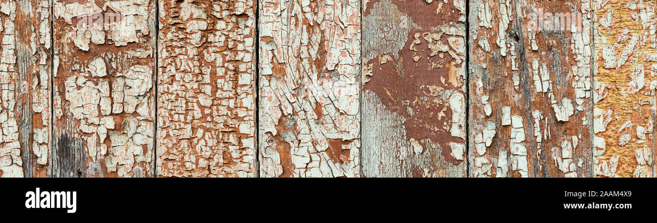Rustic timber background with great texture, close up view. Cracked paint on wooden planks, aged by time. Super wide natural background with traces of Stock Photo