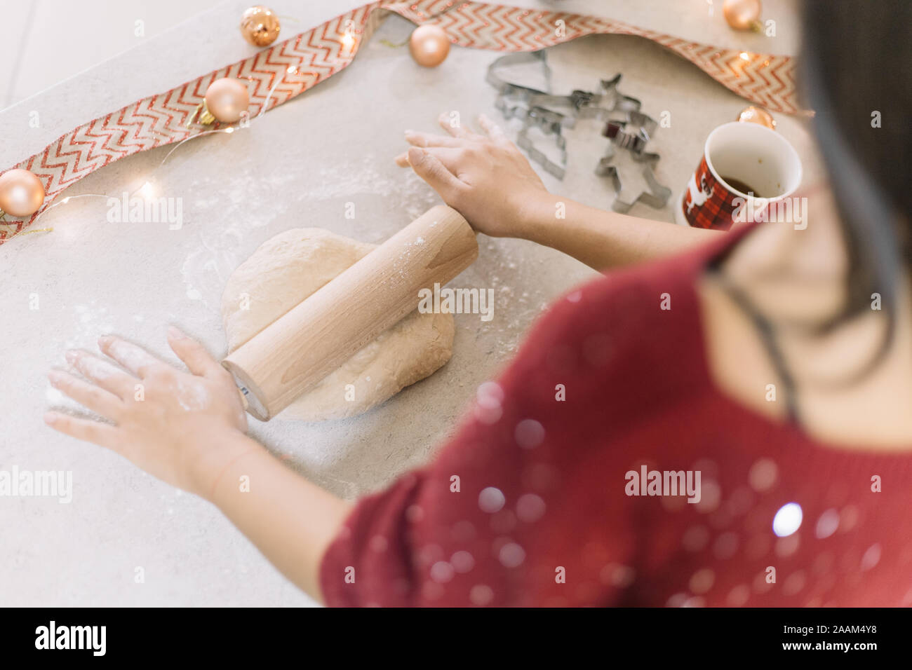 High angle view of womans hands rolling cookie dough Stock Photo