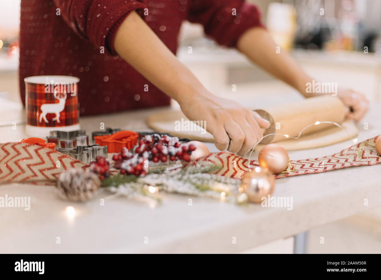 Side view of womans hands rolling cookie dough Stock Photo
