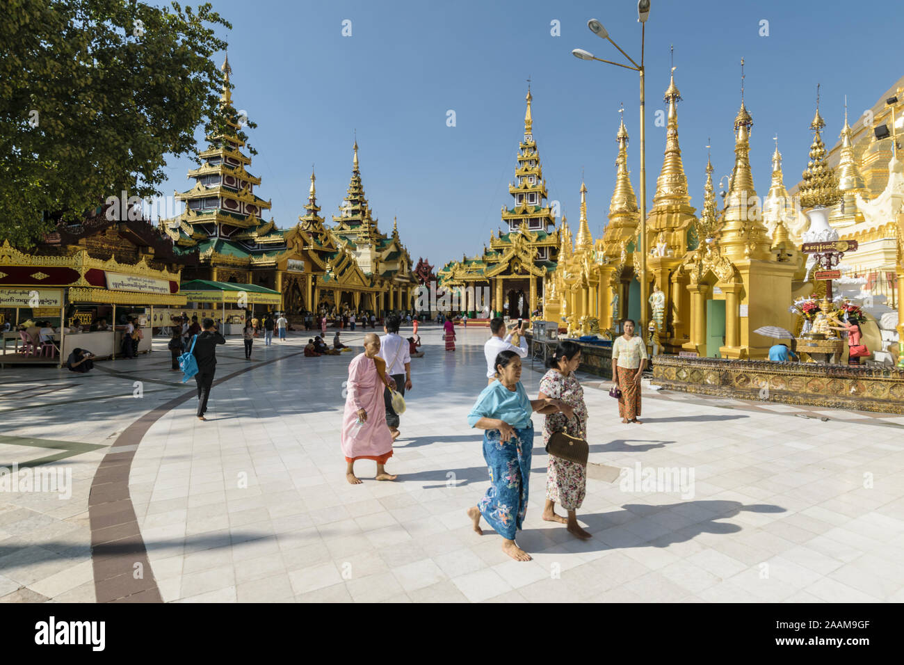 worshippers and tourists at the Shwedagon pagoda site. This Buddhist temple is the most important one in the country. Stock Photo
