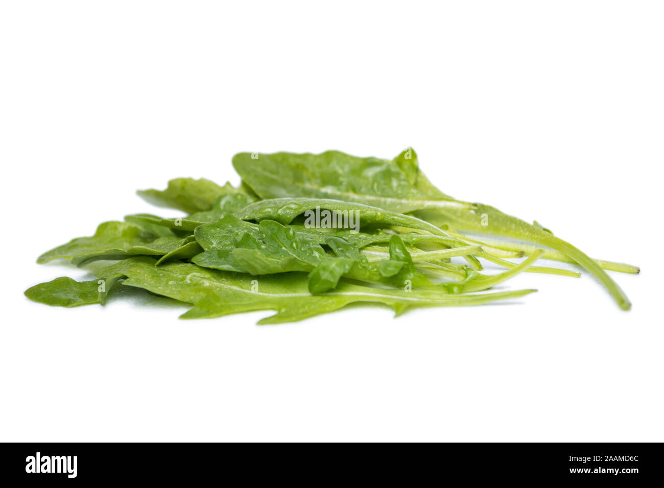 Closeup leaves of fresh arugula rucola isolated on white background. Stock Photo