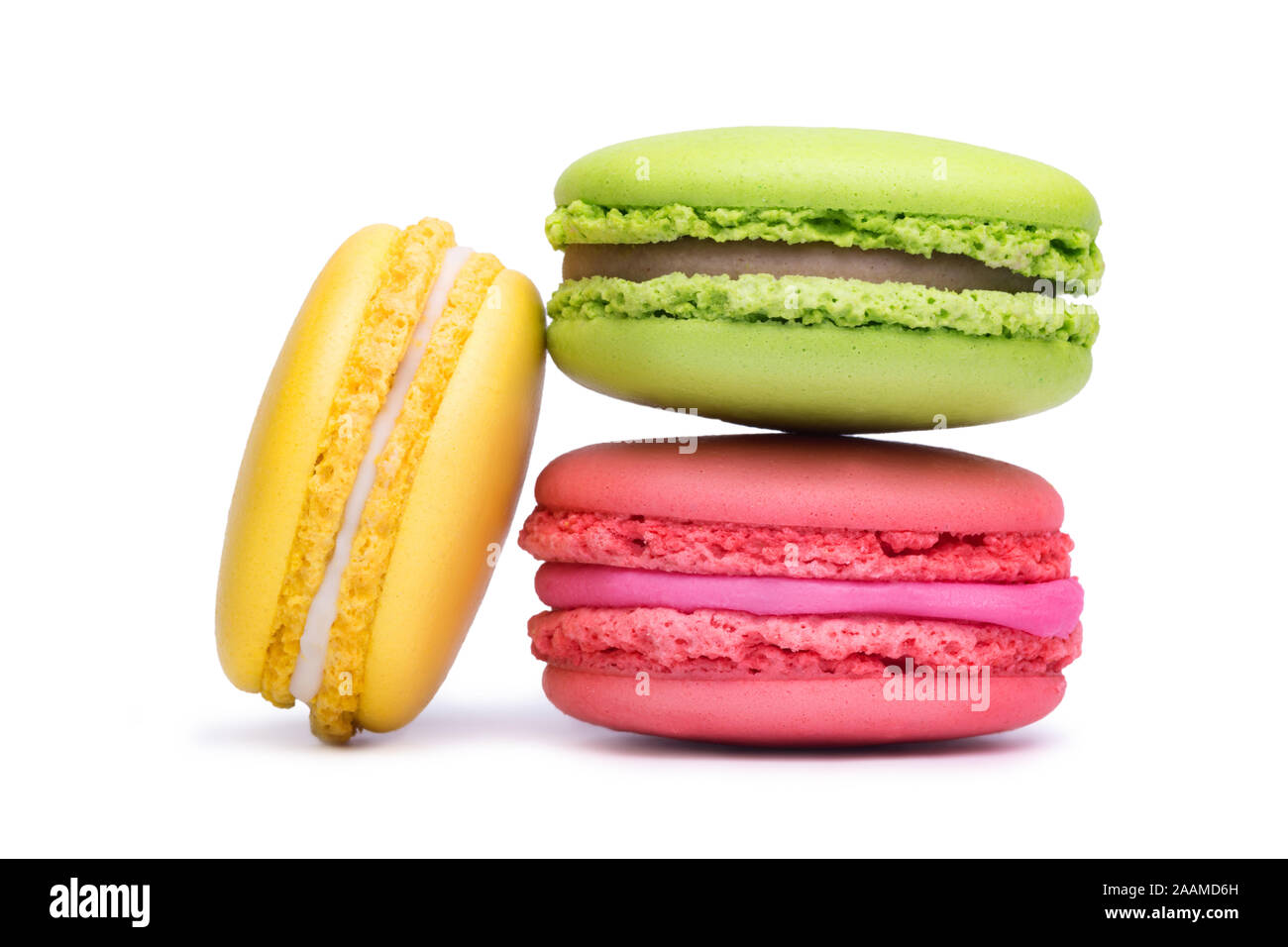 Yellow, pink and green macaron cookies isolated on white background Stock Photo