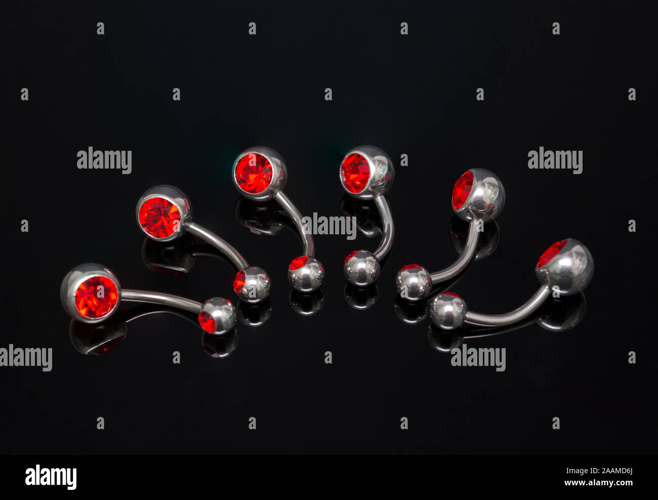 Set of belly piercing on black background. Body jewelry. Stock Photo