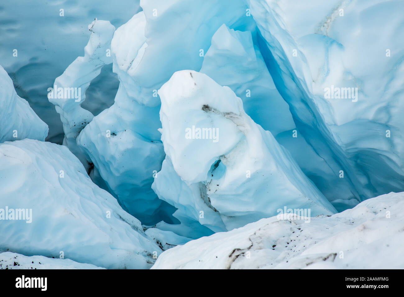 In an icefall of the Matanuska Glacier, deep in the Alaskan wilderness,  several crevasses split the blue ice into tall unstable seracs ready to  fall a Stock Photo - Alamy