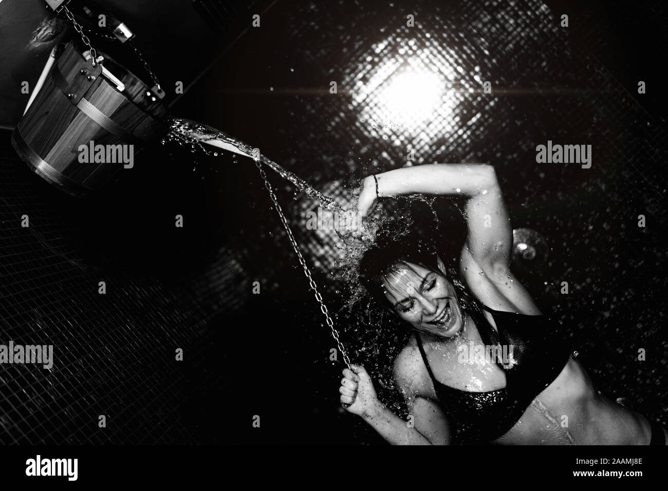 Woman Taking A Cold Shower From Ice Bucket Stock Photo Alamy