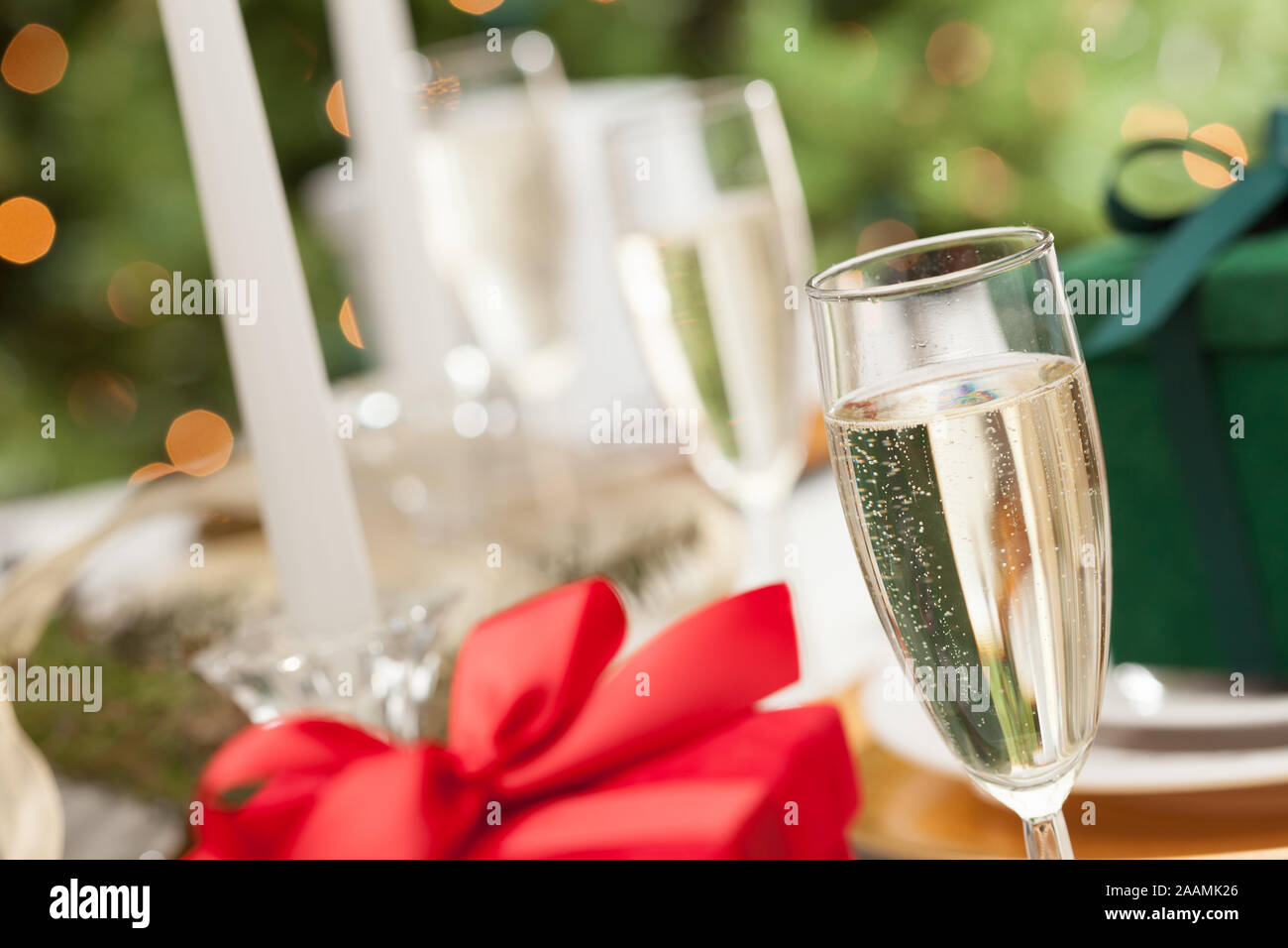 Champagne Glass and Christmas Gift with Place Setting Abstract at Table