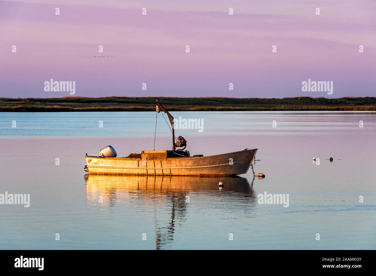 Small motorboat at sunrise, Crackatuxet Cove, South Beach, Martha's Vineyard, Massachusetts, USA Stock Photo