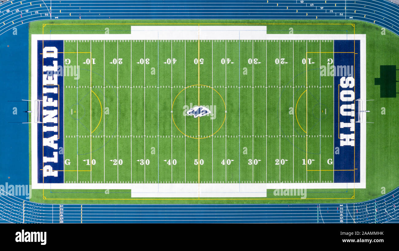 A drone/aerial view of the Plainfield South High School football field, surrounded by a blue running track. Stock Photo