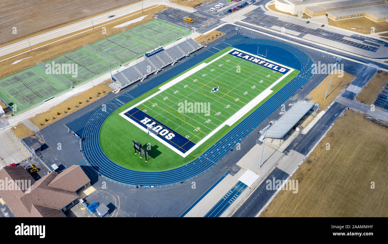 A drone/aerial view of the Plainfield South High School football and soccer stadium, surrounded by a blue running track. Stock Photo