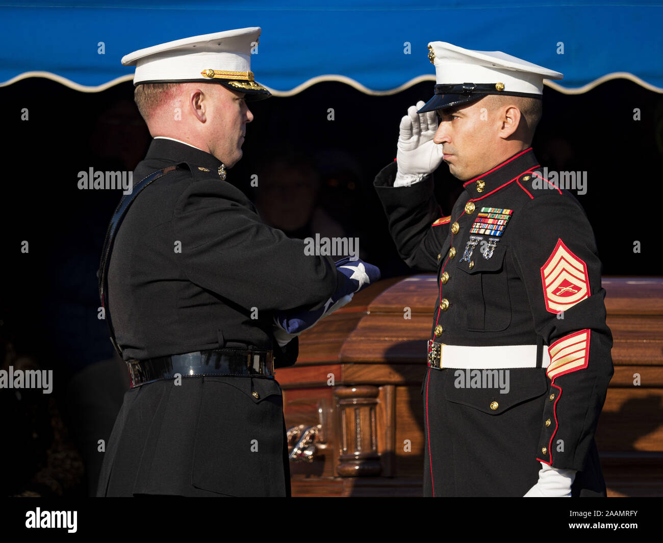 Des Moines, Iowa, USA. 22nd Nov, 2019. A member of the US Marine Corps Honor Guard, right, salutes U.S. Marine Corps Maj. JOHN SHECKELLS, left, during the reinterment service of US Marine Reserve Corps Private Channing Whitaker. Whitaker died in the Battle of Tarawa on Nov. 22, 1943. He was buried on Betio Island, in the Gilbert Islands, and his remains were recovered in March 2019. He was identified by a DNA match with surviving family members in Iowa. Credit: ZUMA Press, Inc./Alamy Live News Stock Photo