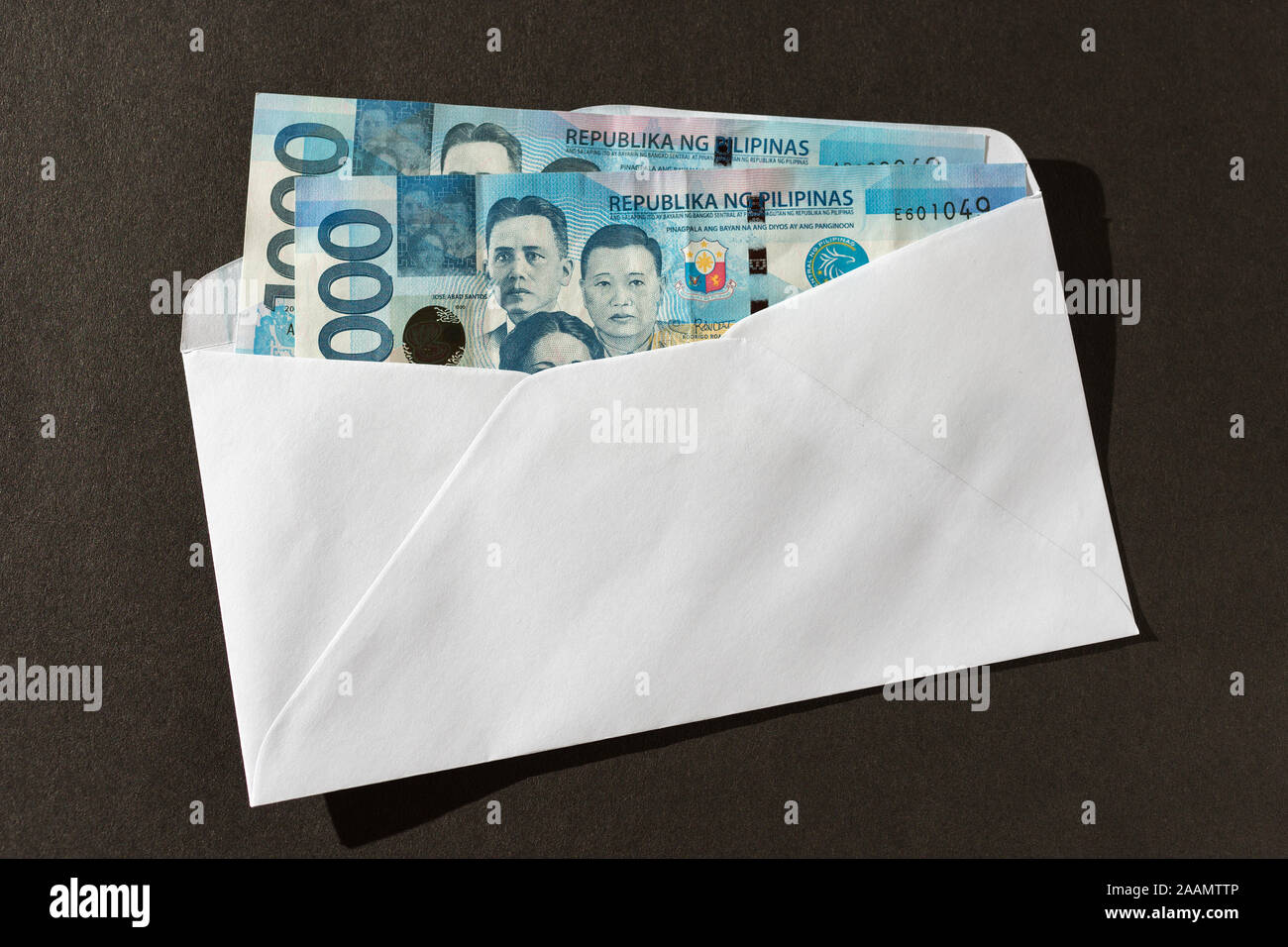Cash banknote of one thousand Philippines in envelope peso paying bills, payment or bribe