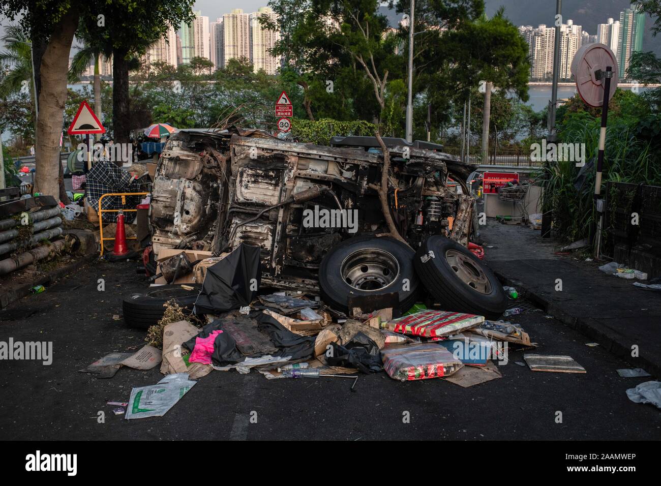 A burned vehicle blocks the entrance to bridge number 2 during the demonstration.After a week of strikes and clashes with police, protesters still occupy the campus of Chinese University of Hong Kong in a day of relative calm. At the end of the day, protesters blocked again Tolo Highway in flash mob actions and then evacuated the campus helped by private drivers after setting the entrance of bridge number 2 on fire. No arrests were made. Stock Photo