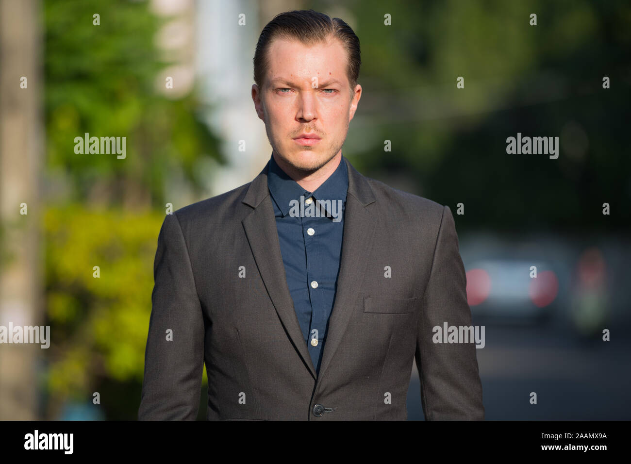 Portrait of young handsome businessman in suit outdoors Stock Photo - Alamy