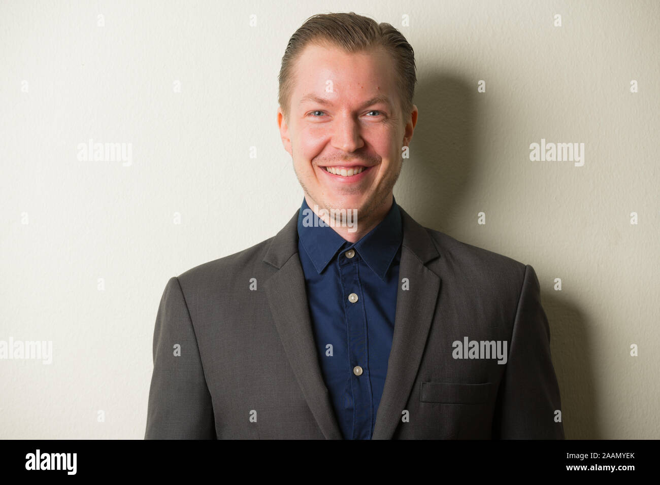 Face of happy young handsome businessman in suit smiling Stock Photo ...
