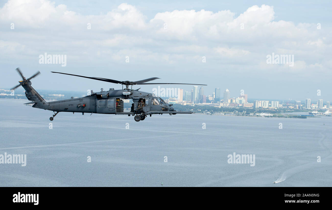 An HH-60 Pave Hawk helicopter assigned to the 305th Rescue Squadron (RQS), Davis-Monthan Air Force Base, Ariz., flies above the waters of Tampa Bay, Fla., Nov. 8, 2019. MacDill Air Force Base hosted the 305th RQS and Special Forces for an exercise. (U.S. Air Force photo by Airman 1st Class Ryan C. Grossklag) Stock Photo