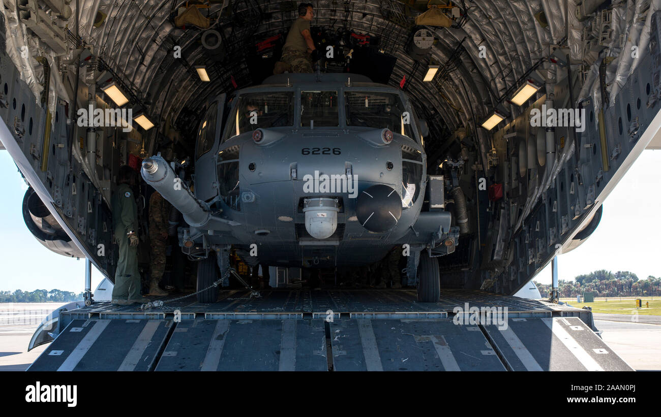 An HH-60 Pave Hawk helicopter assigned to the 305th Rescue Squadron (RQS), Davis-Monthan Air Force Base, Ariz., sits inside a C-17 Globemaster III assigned to the 436th Airlift Wing, Dover Air Force Base, Dela., at MacDill Air Force Base, Fla., Nov. 20, 2019. MacDill hosted the 305th RQS as they participated in a Joint Force deployment exercise with U.S. Army Special Forces members. (U.S. Air Force photo by Airman 1st Class Ryan C. Grossklag) Stock Photo