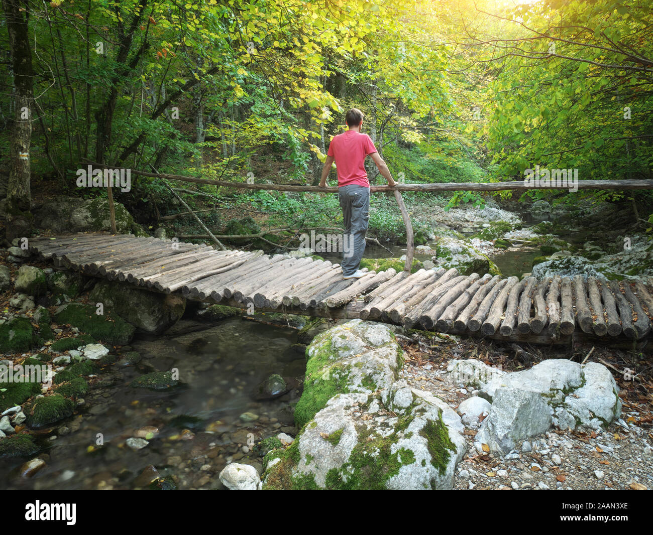 Young man standing bridge hi-res stock photography and images - Alamy