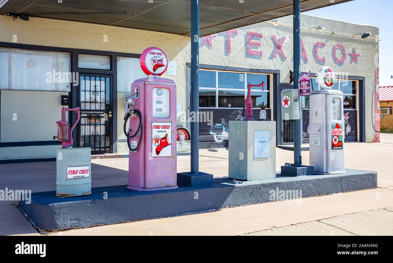 New Mexico, USA. May 14, 2019. Old-fashioned fuel pumps at gas station next to historic route 66. Building with logo background. Stock Photo
