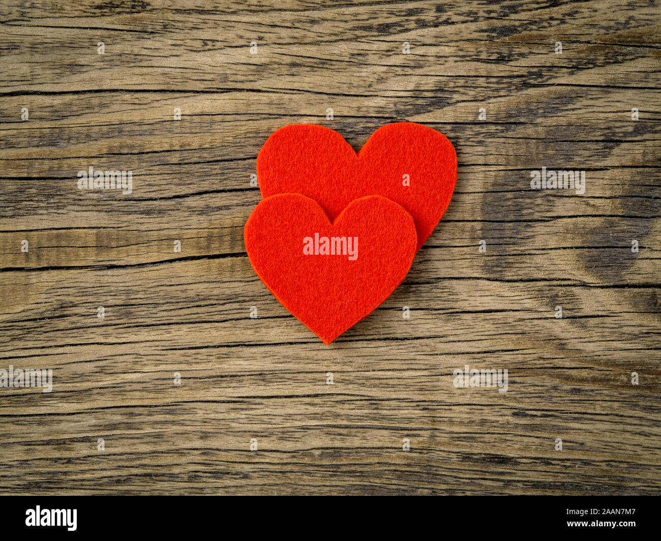 two bright red hearts on dark vintage texture old wood background ...