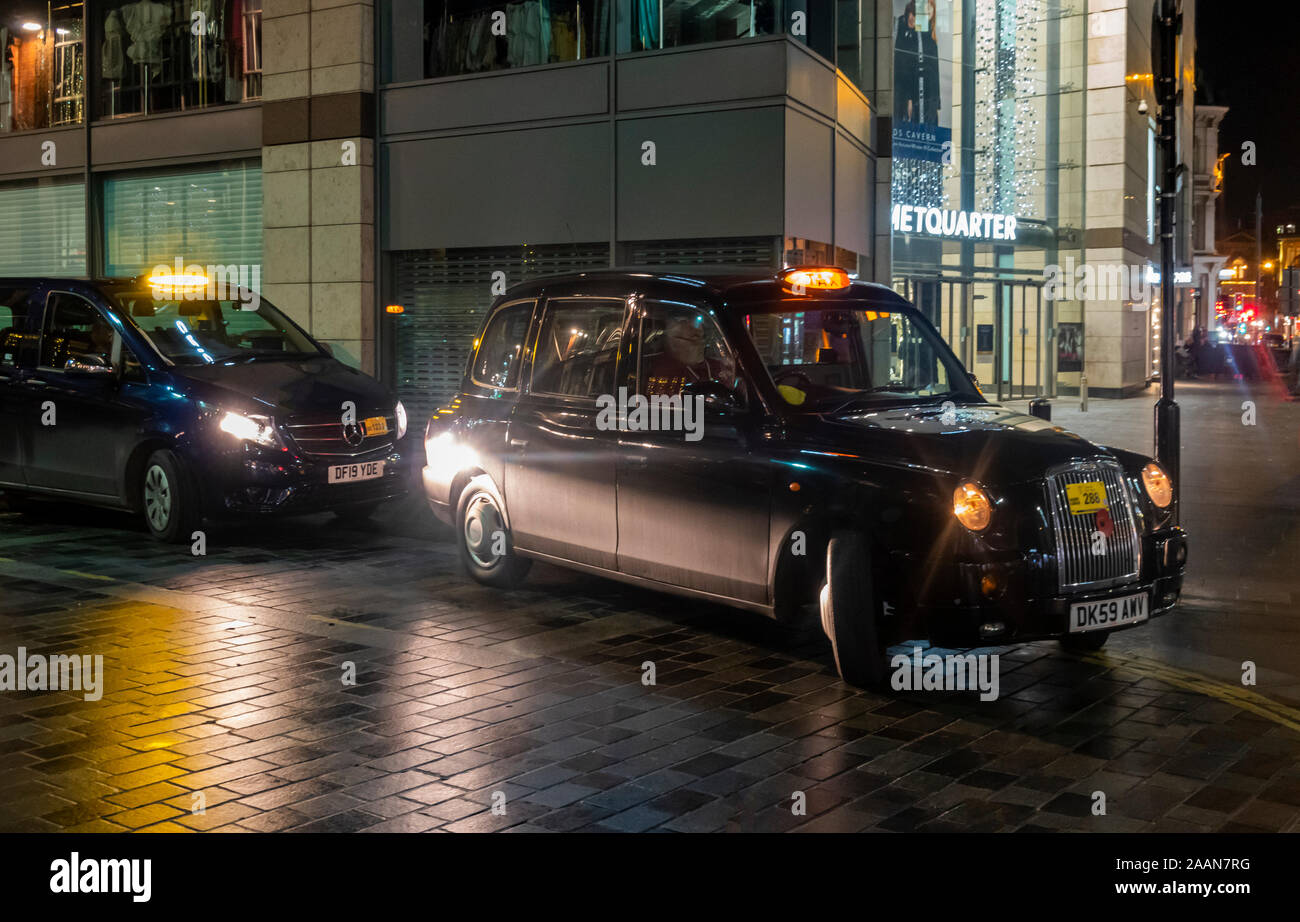 Two hackney carriages at night in Liverpool City Centre Stock Photo