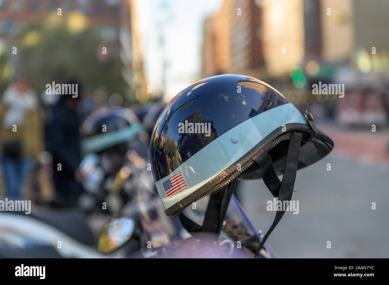 Police helmet with American flag sticker hanging off a police scooter