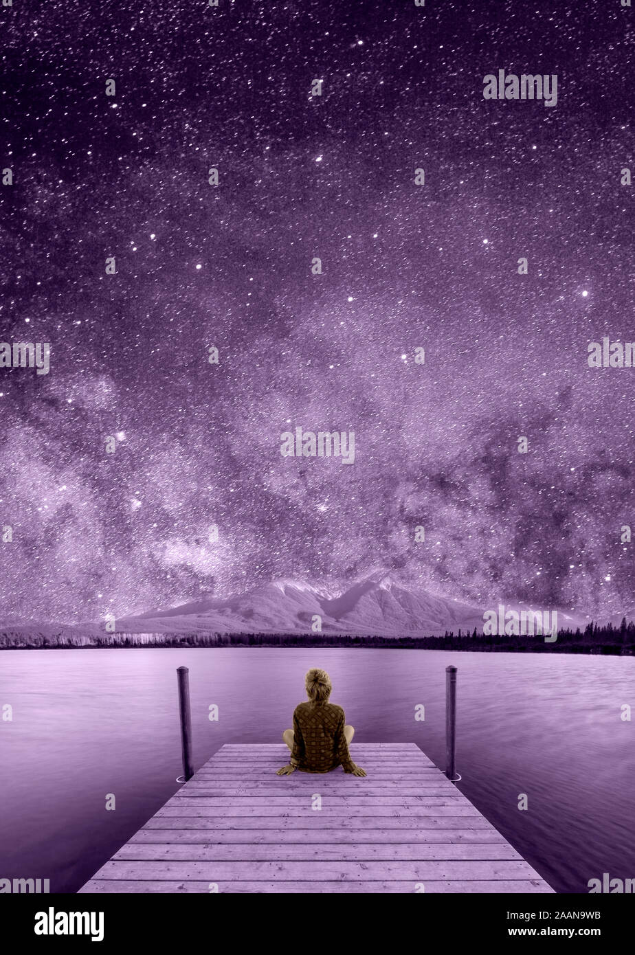 Fantastic night starry sky. Beautiful girl watching the stars ...