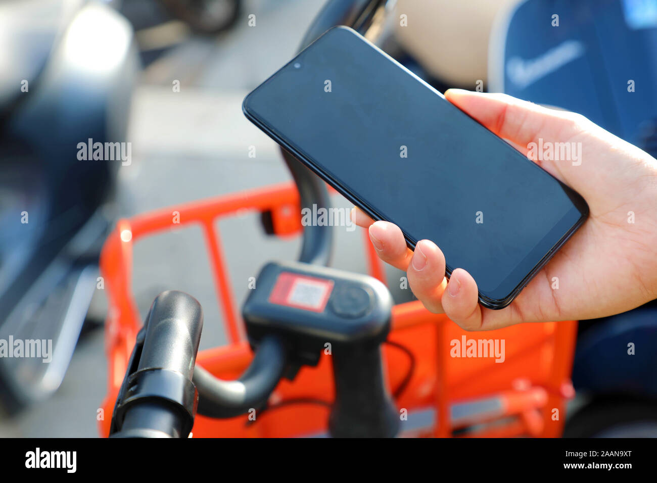 Shared bikes. Hand using smartphone scanning the QR code of shared bike