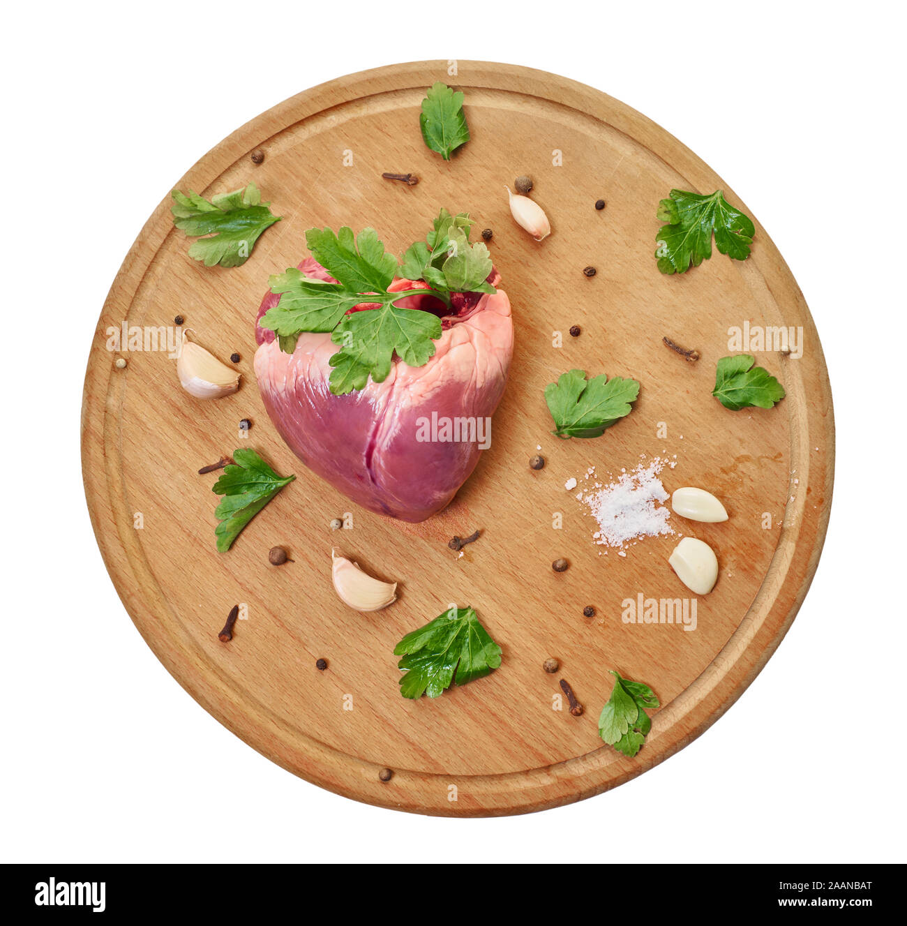 raw meat, beef heart with seasonings, white isolated background Stock